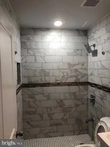 a white toilet sitting next to a bathroom sink