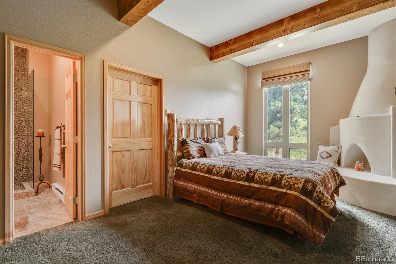 3024 High Road Evergreen, CO 80439 - Photo 29 of 38 a bedroom with a bed and a window