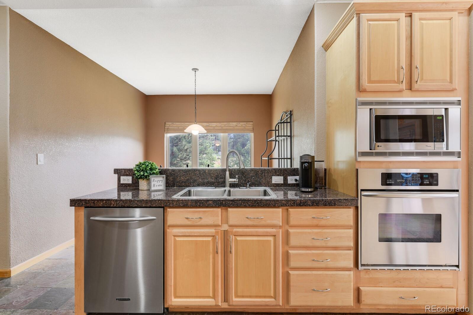 3024 High Road Evergreen, CO 80439 - Photo 9 of 38 a kitchen with granite countertop a sink and cabinets
