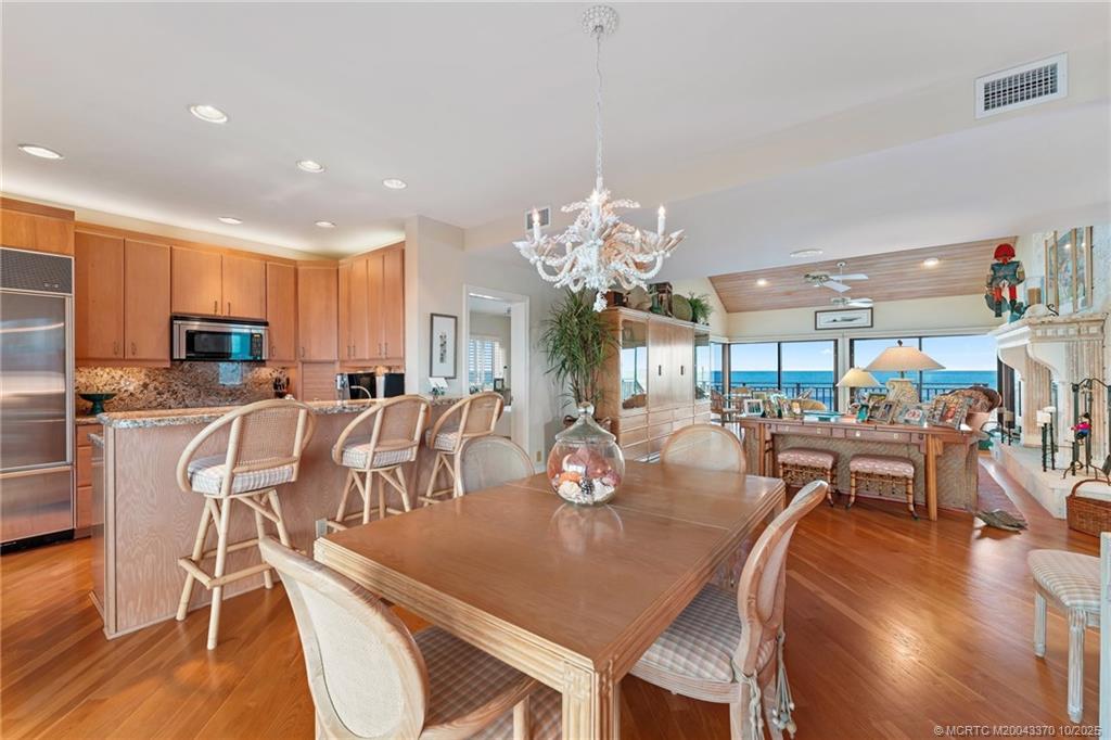 777 Southeast MacArthur Boulevard Stuart, FL 34996 - Photo 13 of 46 a view of a dining room with furniture and chandelier