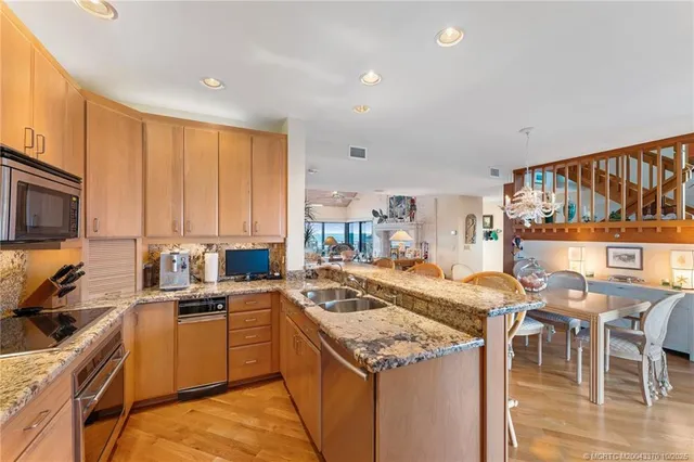 a kitchen with a stove a sink a microwave and wooden cabinets