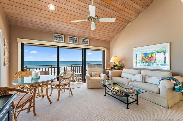 a living room with furniture a ceiling fan and a window