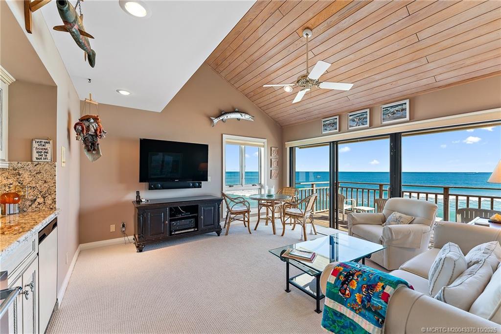 777 Southeast MacArthur Boulevard Stuart, FL 34996 - Photo 19 of 46 a living room with furniture and a flat screen tv