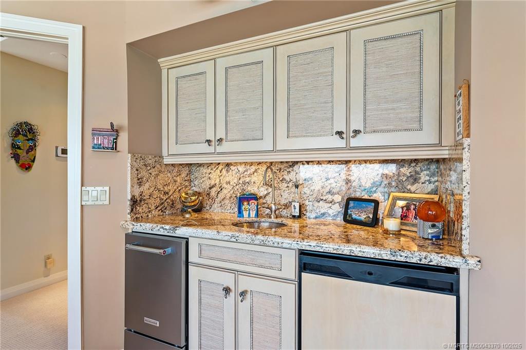 777 Southeast MacArthur Boulevard Stuart, FL 34996 - Photo 20 of 46 a kitchen with stainless steel appliances granite countertop a sink and cabinets