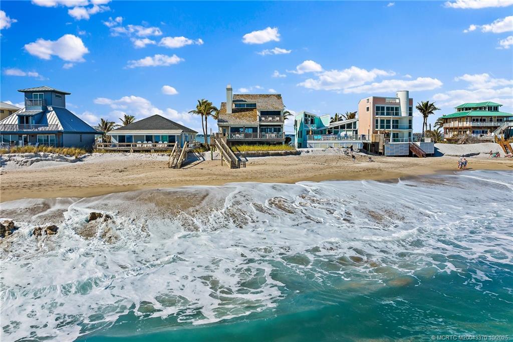 777 Southeast MacArthur Boulevard Stuart, FL 34996 - Photo 2 of 46 a car parked in front of house with a yard