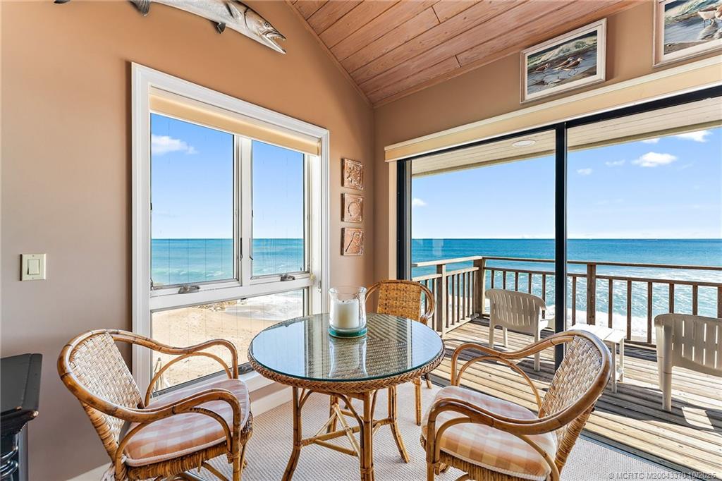 777 Southeast MacArthur Boulevard Stuart, FL 34996 - Photo 21 of 46 a balcony with chairs and glass door