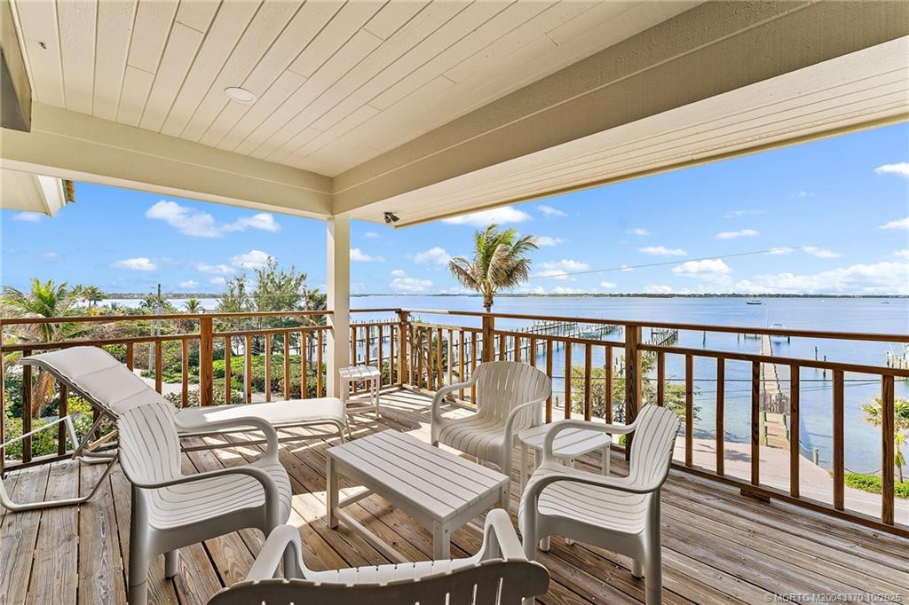 777 Southeast MacArthur Boulevard Stuart, FL 34996 - Photo 32 of 46 a balcony with chairs and city view