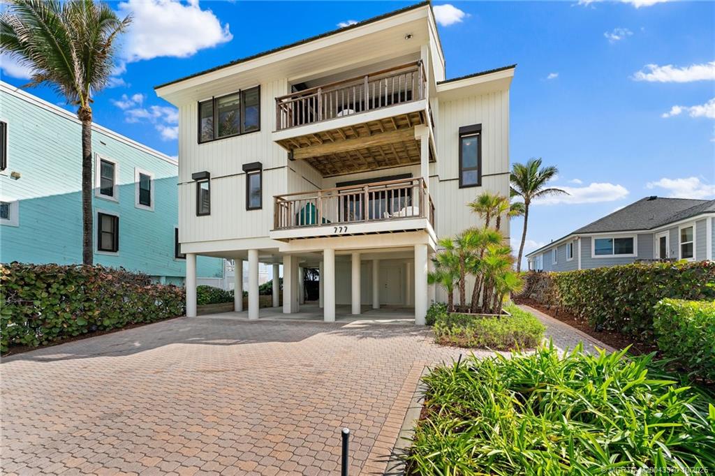 777 Southeast MacArthur Boulevard Stuart, FL 34996 - Photo 34 of 46 a front view of a house with a yard