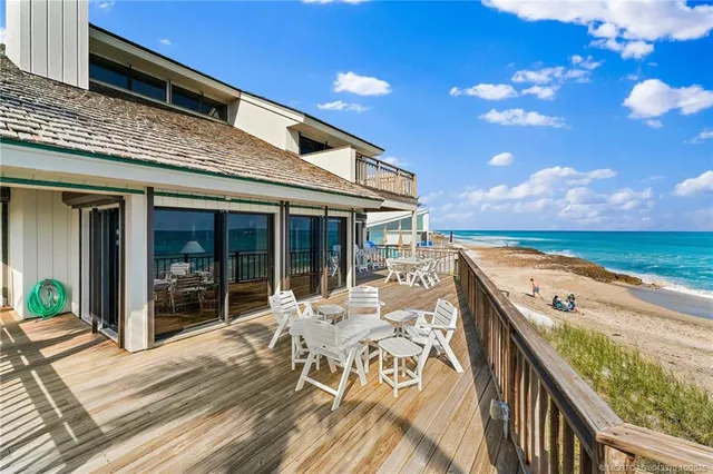 a view of a terrace with wooden floor and furniture