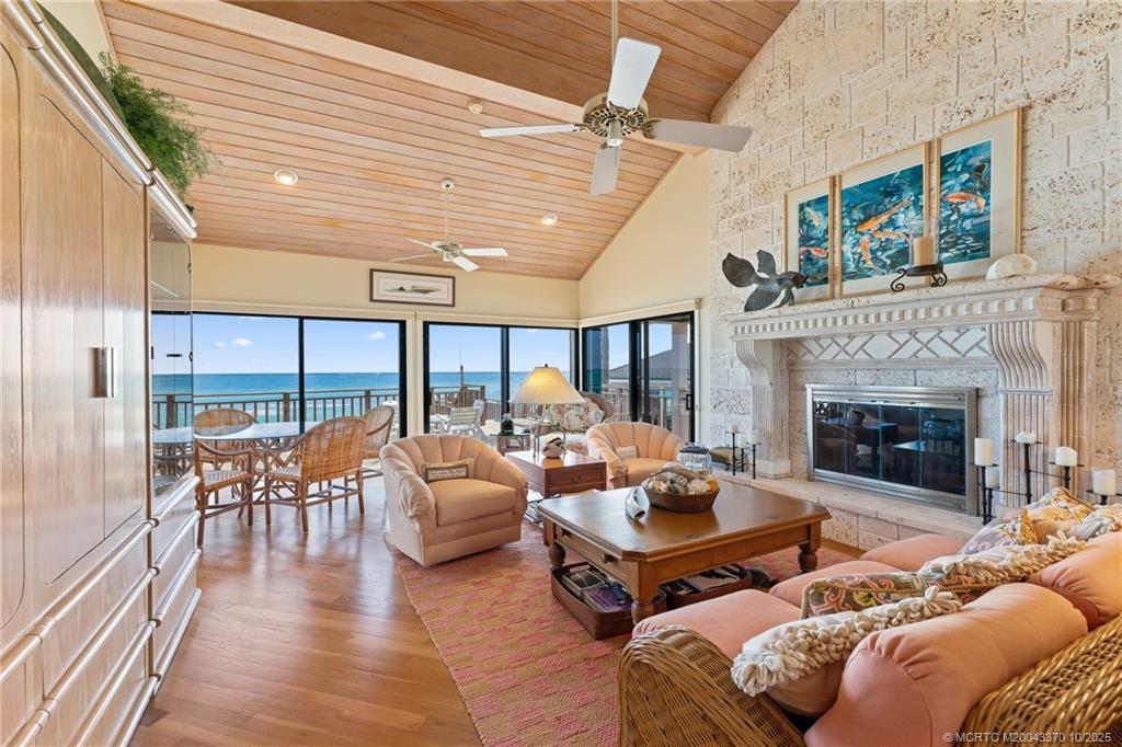 777 Southeast MacArthur Boulevard Stuart, FL 34996 - Photo 6 of 46 a living room with furniture fireplace and a floor to ceiling window