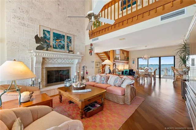 a living room with furniture a fireplace and a large window