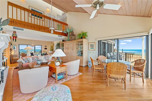 a living room with patio furniture and a floor to ceiling window