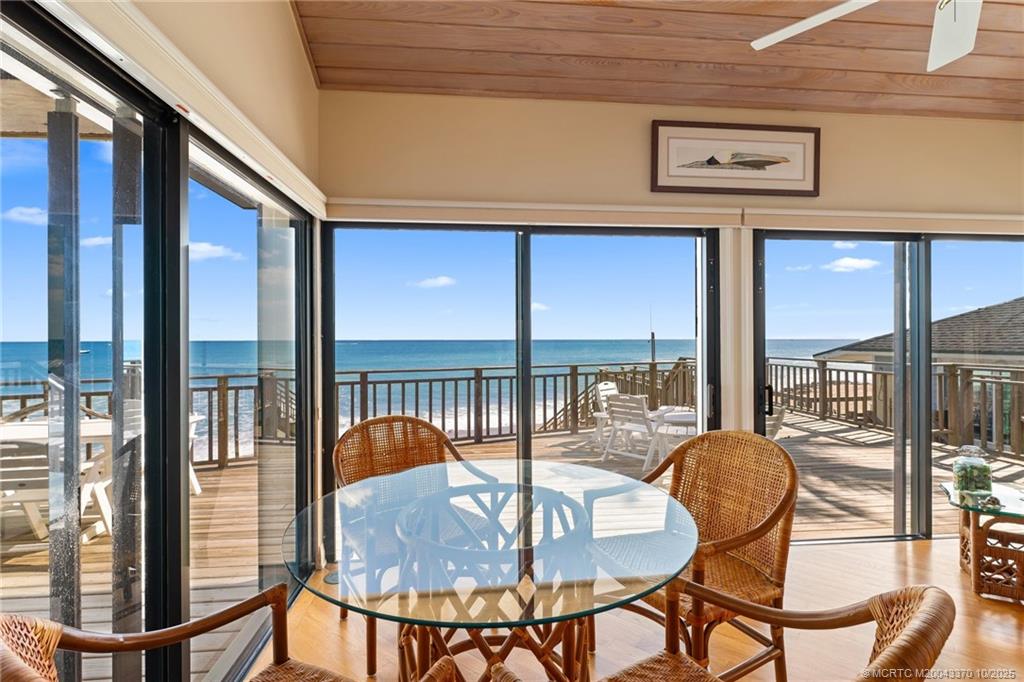777 Southeast MacArthur Boulevard Stuart, FL 34996 - Photo 10 of 46 a view of a dining room with furniture large windows and wooden floor