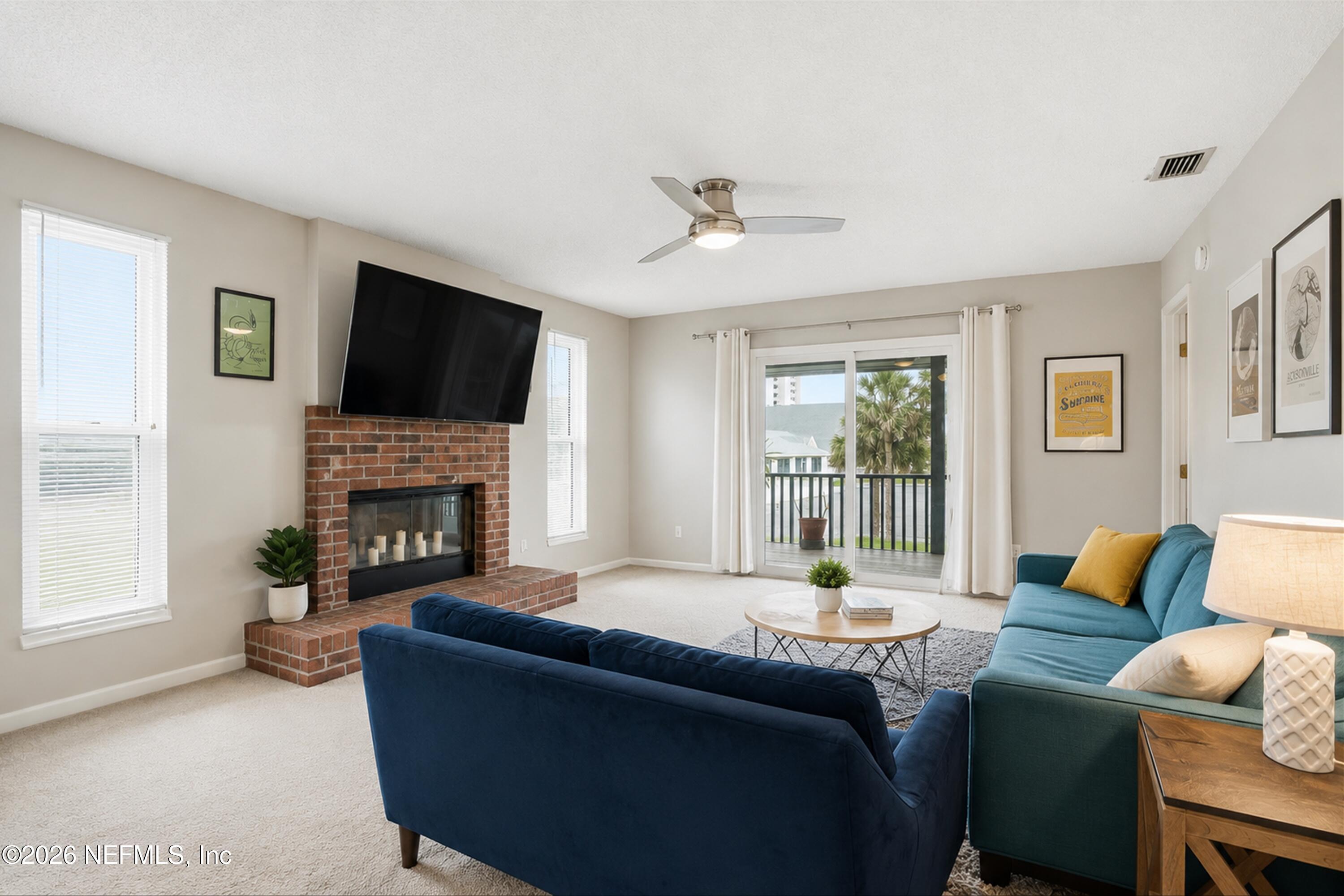 124 Hopkins Street Neptune Beach, FL 32266 - Photo 7 of 44 a living room with furniture a fireplace and a flat screen tv