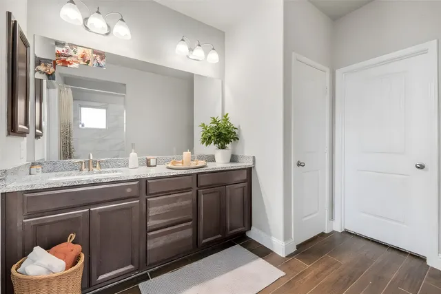a bathroom with a double vanity sink and a mirror