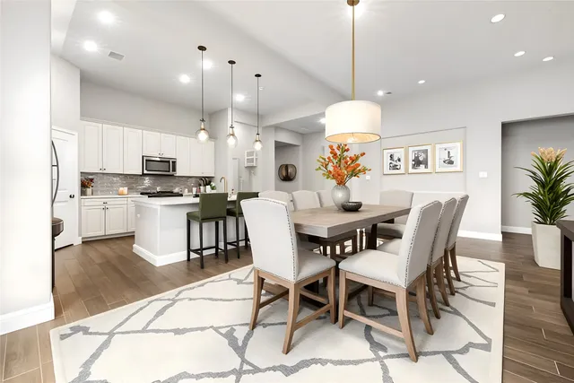 a kitchen with kitchen island granite countertop a table and chairs in it