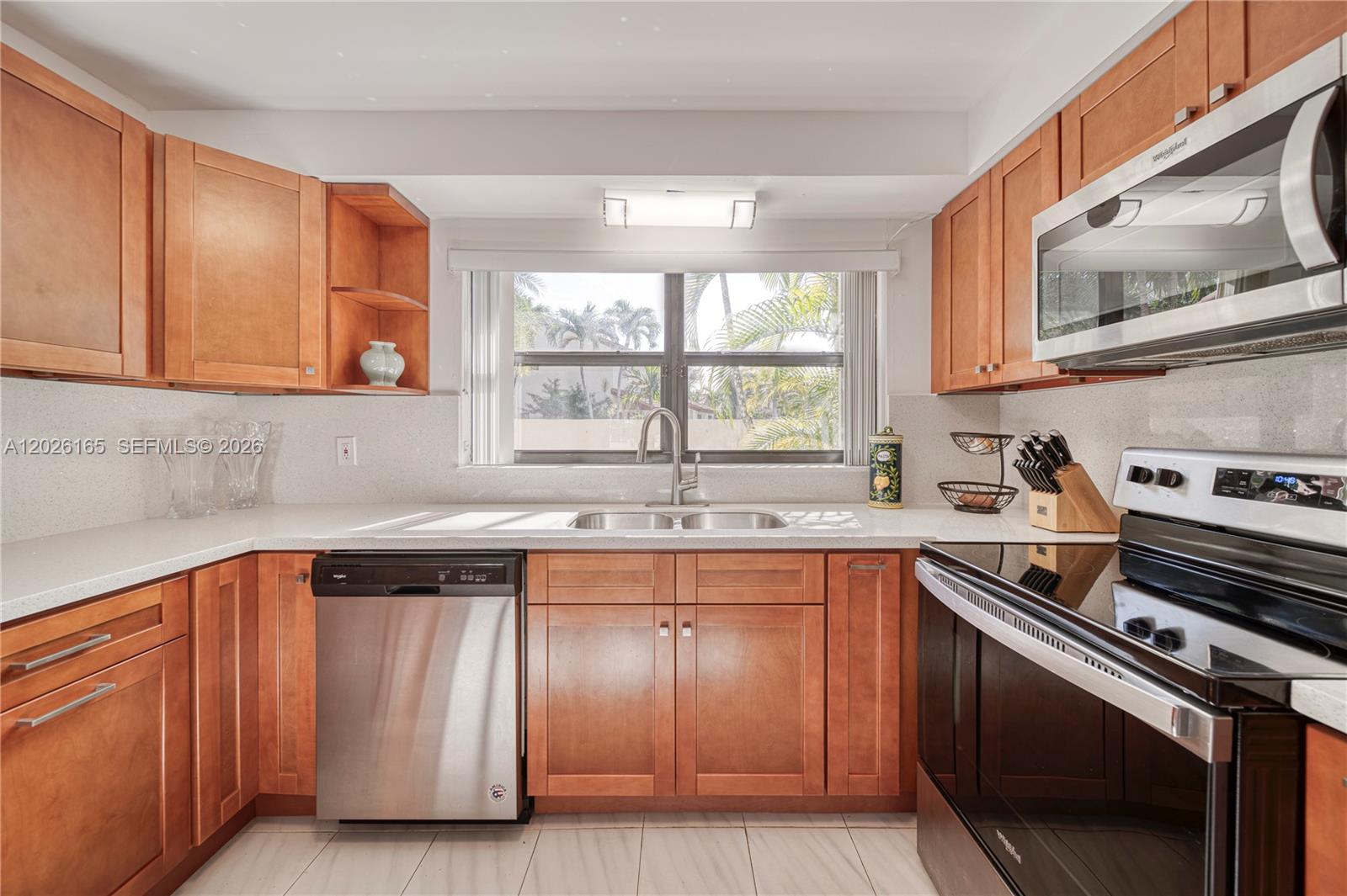 13337 Southwest 64th Lane Miami, FL 33183 - Photo 12 of 36 a kitchen with a sink stove top oven and cabinets