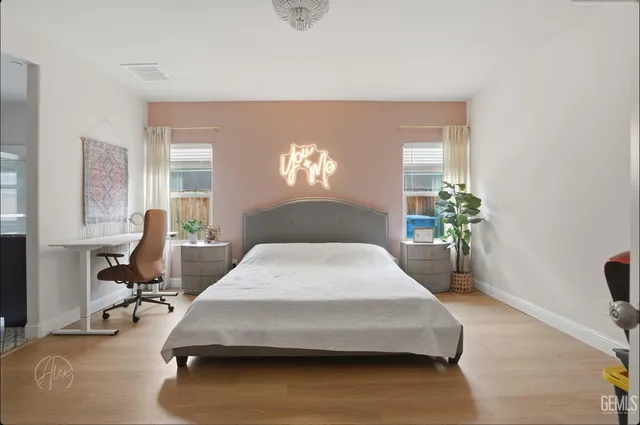 a bedroom with bed and glass windows