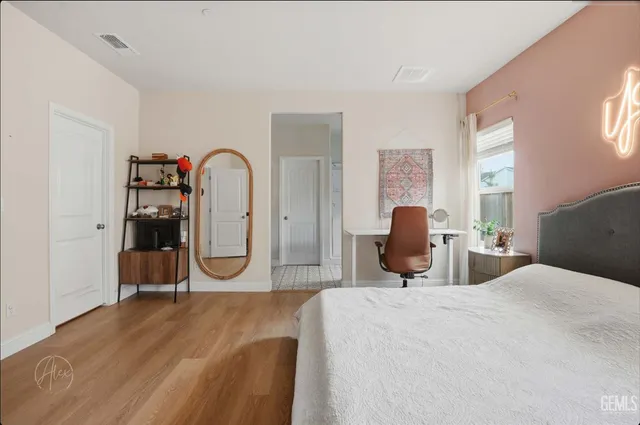 a bathroom with a granite countertop sink a mirror and shower