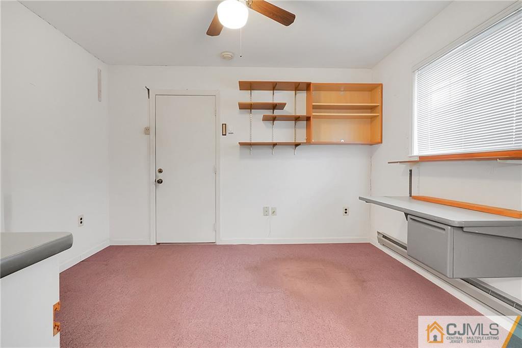 793 Pompton Road, Unit D Monroe Township, NJ 08831 - Photo 11 of 23 a view of a bedroom with window and cabinet