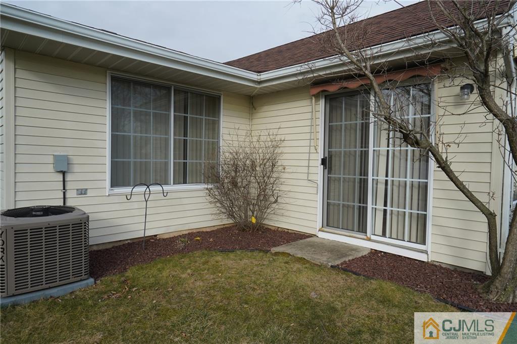 793 Pompton Road, Unit D Monroe Township, NJ 08831 - Photo 22 of 23 a view of a house with a small yard and wooden floor and fence