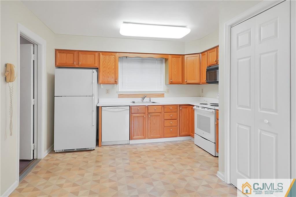 793 Pompton Road, Unit D Monroe Township, NJ 08831 - Photo 5 of 23 a kitchen with a stove a refrigerator and a sink