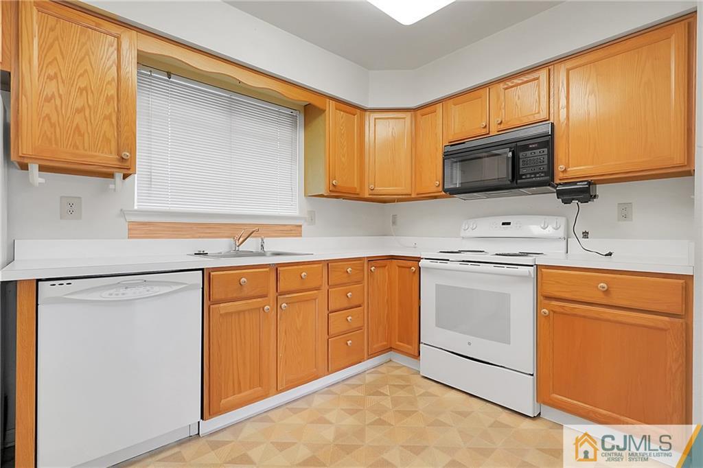 793 Pompton Road, Unit D Monroe Township, NJ 08831 - Photo 6 of 23 a kitchen with stainless steel appliances granite countertop a sink stove and refrigerator