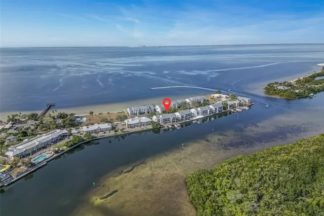 an aerial view of a house with swimming pool and outdoor seating