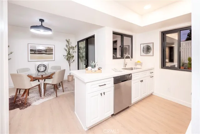 a large white room with mirror and furniture
