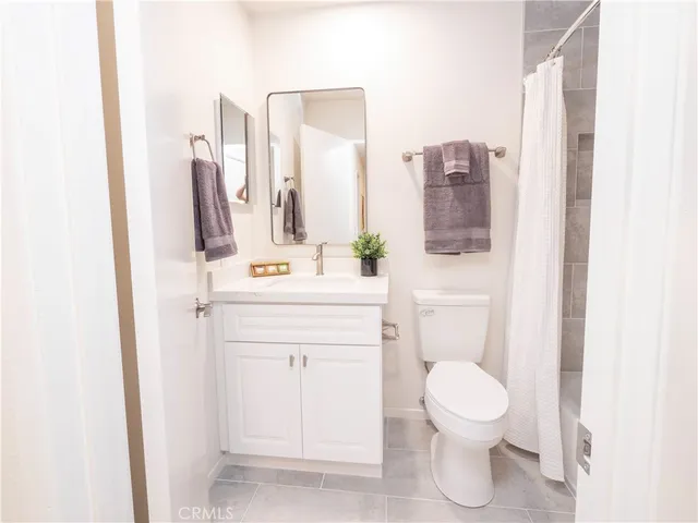 a bath tub sitting next to a white toilet