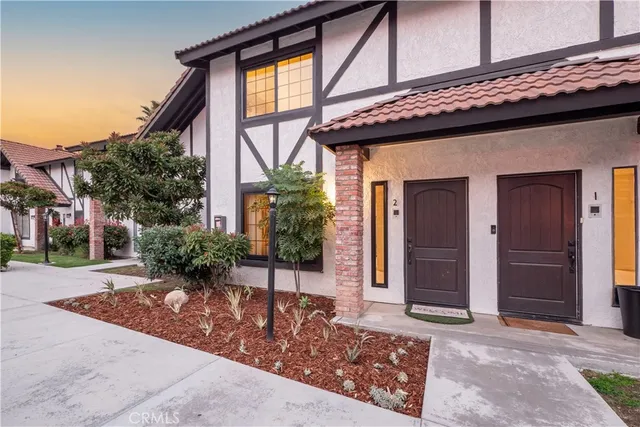 a front view of a building with potted plants