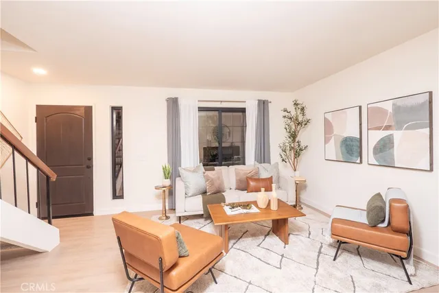 a living room with furniture and a potted plant