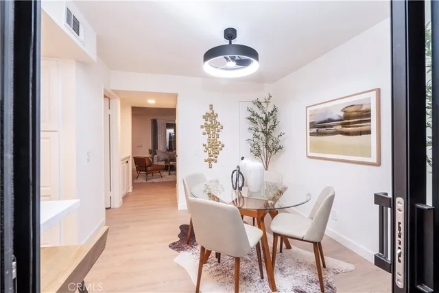 a view of a dining room with furniture and chandelier