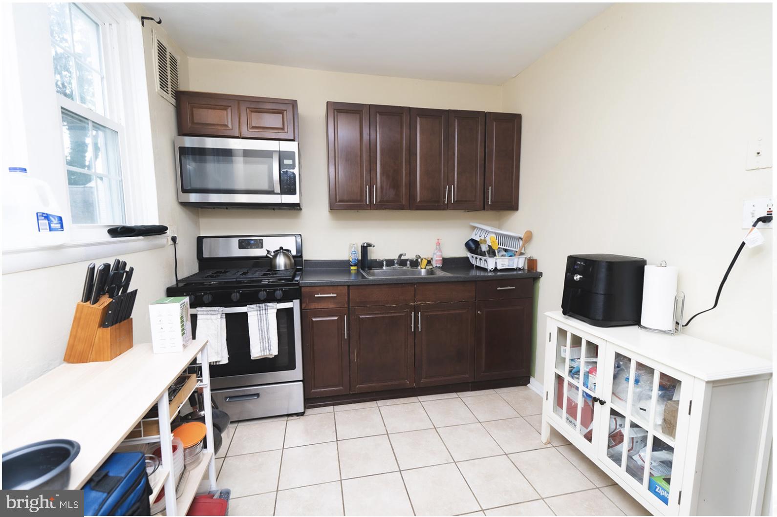 3224 Marshall Road Drexel Hill, PA 19026 - Photo 12 of 24 a kitchen with stainless steel appliances a stove a sink and a microwave