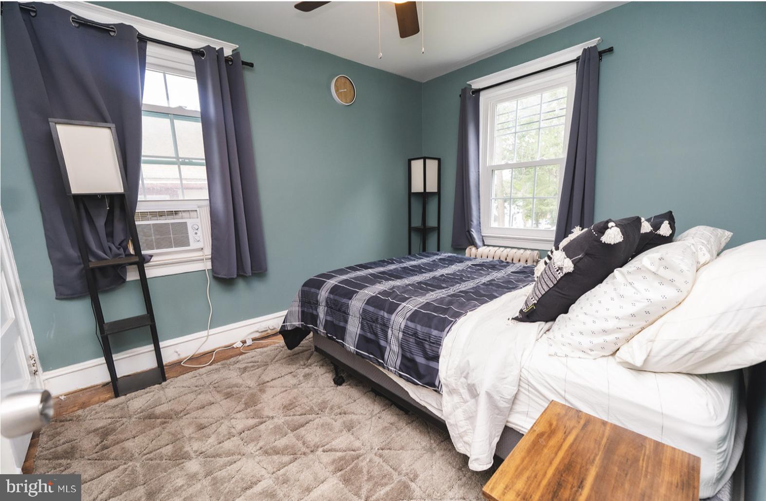 3224 Marshall Road Drexel Hill, PA 19026 - Photo 20 of 24 a bedroom with a bed flat screen tv and a large window