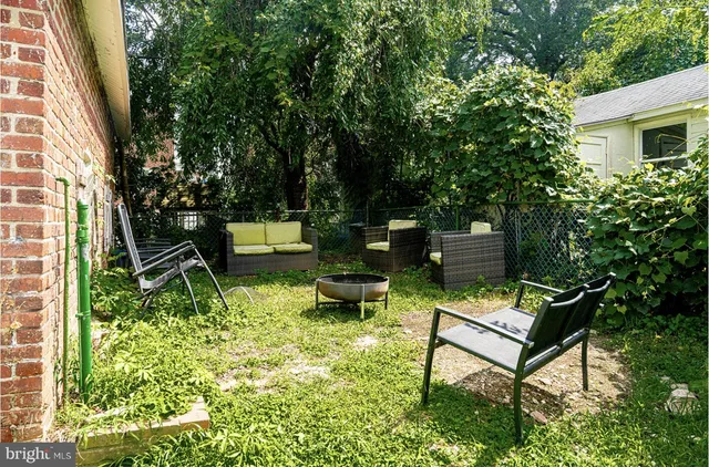 a view of a backyard with sitting area