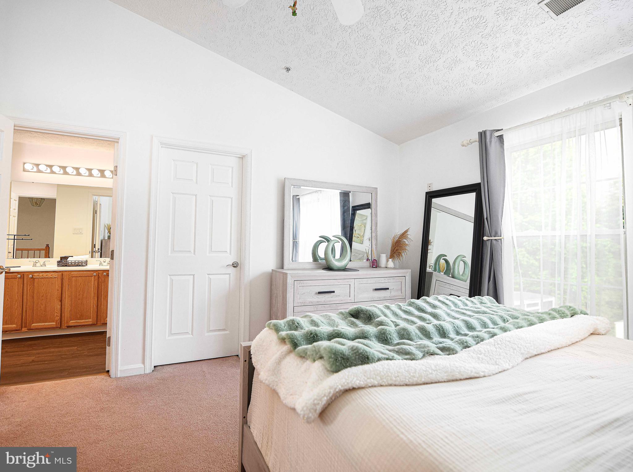 518 MacIntosh Circle Joppa, MD 21085 - Photo 17 of 29 a bedroom with a large bed and a chandelier