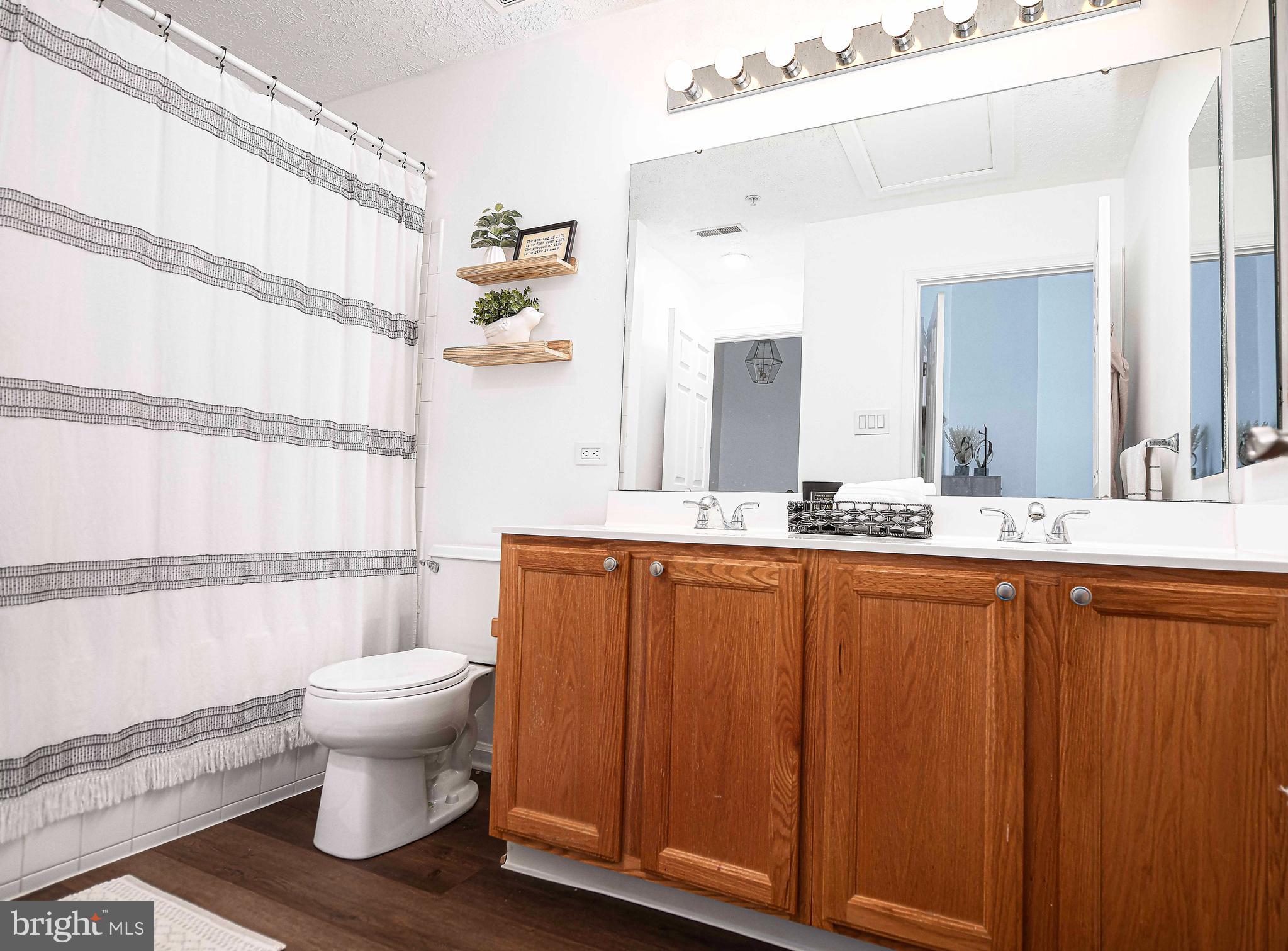 518 MacIntosh Circle Joppa, MD 21085 - Photo 18 of 29 a bathroom with a sink a toilet a mirror and shower