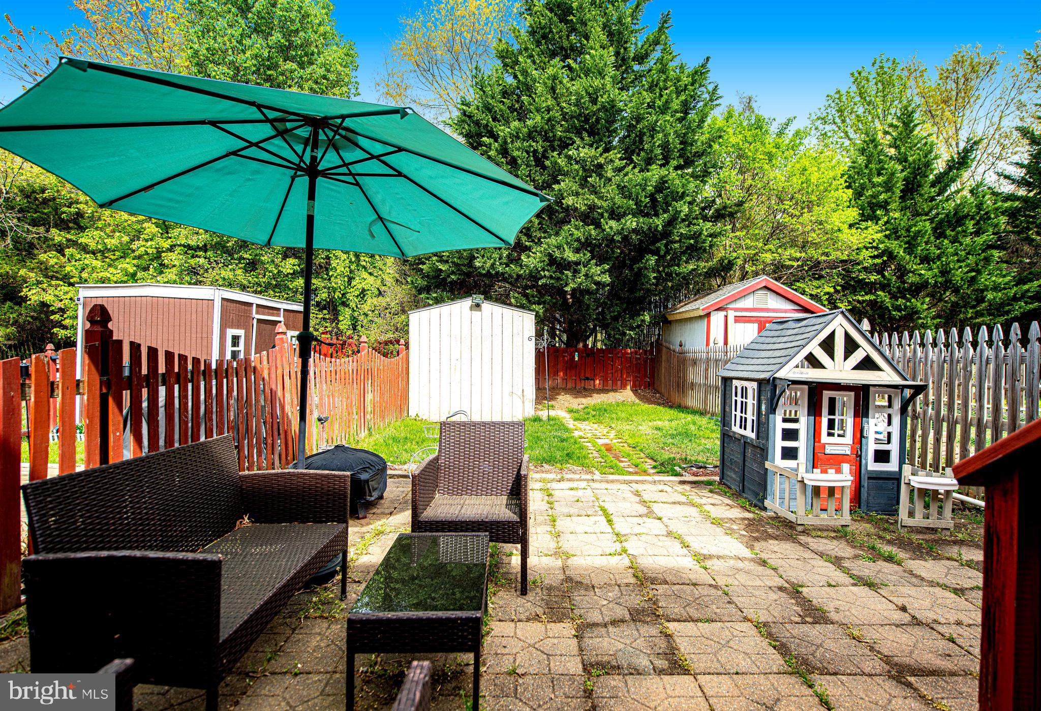 518 MacIntosh Circle Joppa, MD 21085 - Photo 24 of 29 a view of a chairs and table under an umbrella in front of house