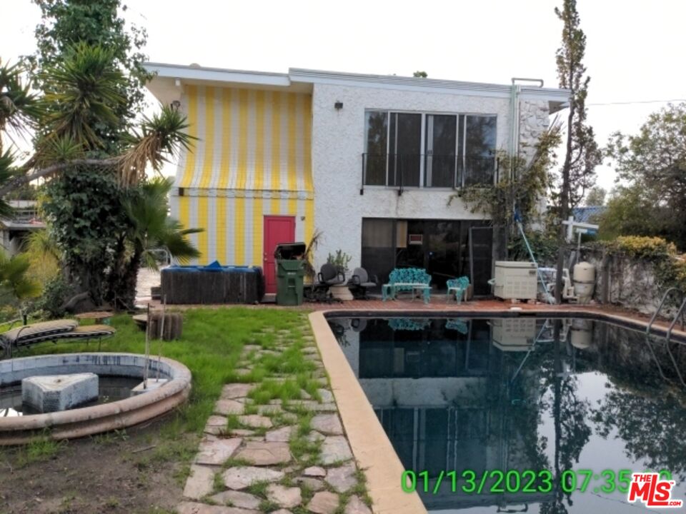 1830 Bel Air Road Los Angeles, CA 90077 - Photo 5 of 12 a view of a house with swimming pool and sitting area
