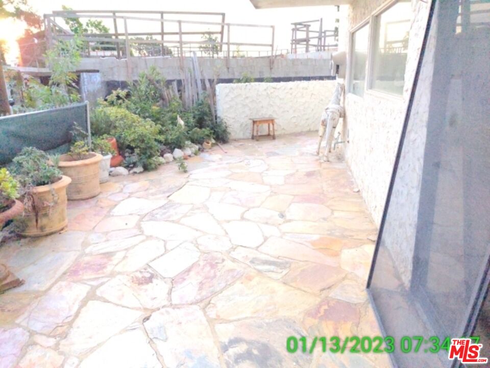 1830 Bel Air Road Los Angeles, CA 90077 - Photo 8 of 12 a view of a chair and table in backyard
