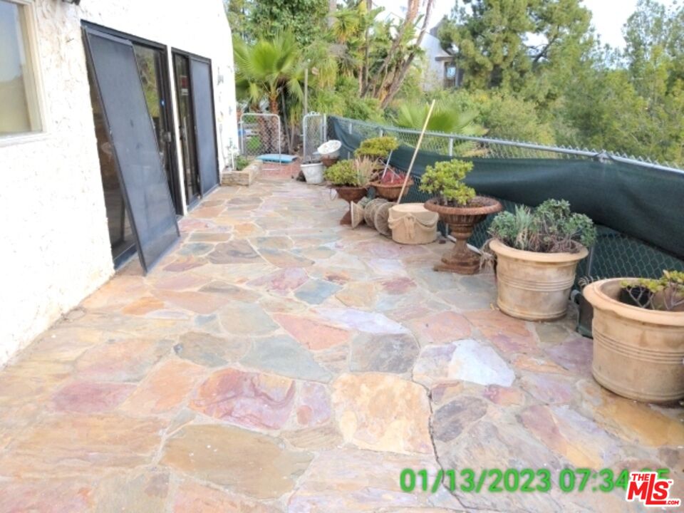1830 Bel Air Road Los Angeles, CA 90077 - Photo 9 of 12 a view of a balcony with chair and potted plants
