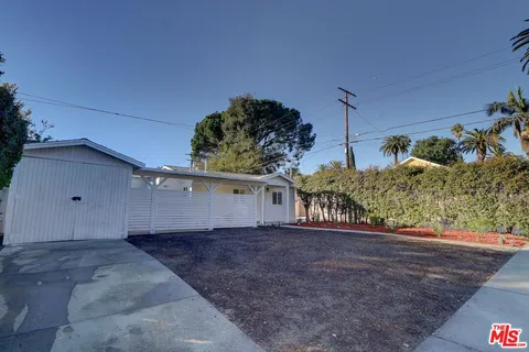 a view of a house with a yard and garage
