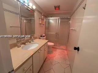 a bathroom with a sink mirror vanity and toilet