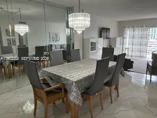 a view of a dining room with furniture and chandelier