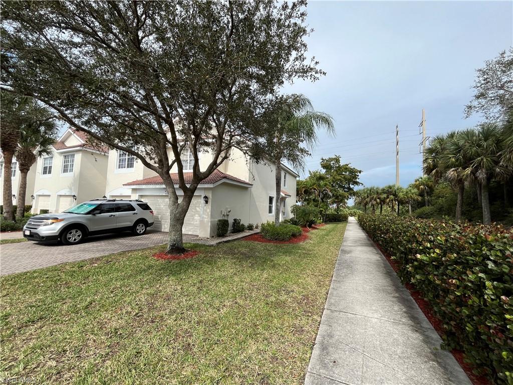 884 Hampton Circle, Unit 159 Naples, FL 34105 - Photo 20 of 28 a view of a house with a yard and pathway