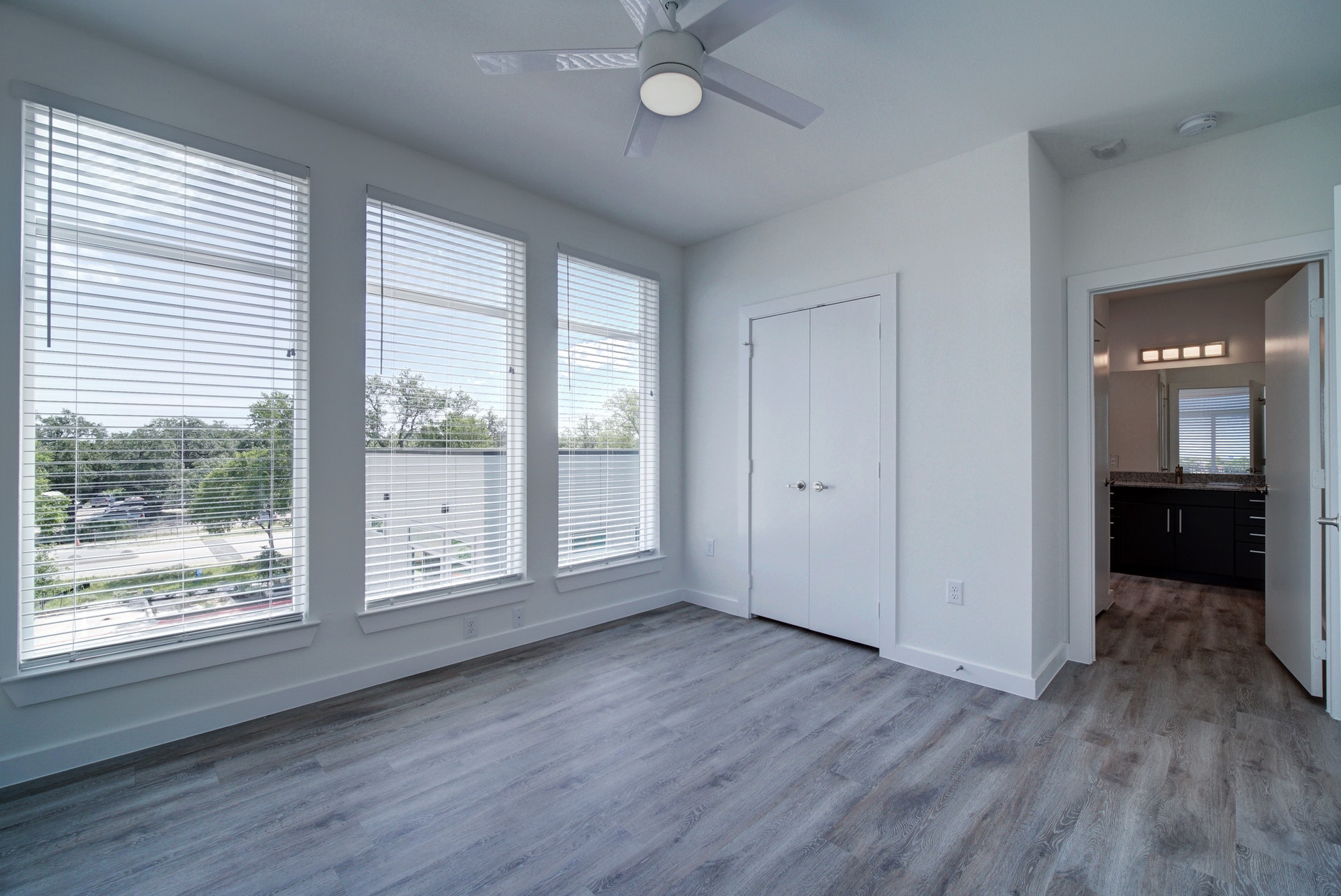 13130 Pond Springs Road, Unit 3214 Austin, TX 78729 - Photo 23 of 40 Unfurnished bedroom with wood finished floors, multiple windows, ceiling fan, and a closet