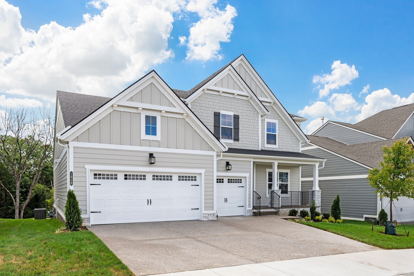 1040 Cherry Tree Drive Mount Juliet, TN 37122 - Photo 2 of 47 a view of a white house next to a yard with plants and trees