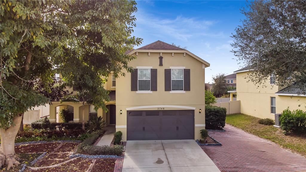 2748 Pythagoras Circle Ocoee, FL 34761 - Photo 1 of 1 a front view of a house with garden