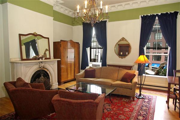 528 Tremont Street, Unit 3 Boston, MA 02116 - Photo 1 of 1 a living room with furniture and chandelier